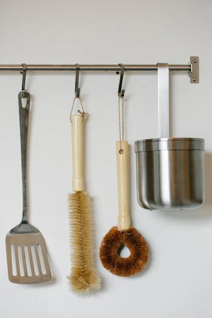 team-02 Unrecognizable man wearing yellow latex gloves washing golden faucet in bathroom while cleaning home with orange sponge and detergent